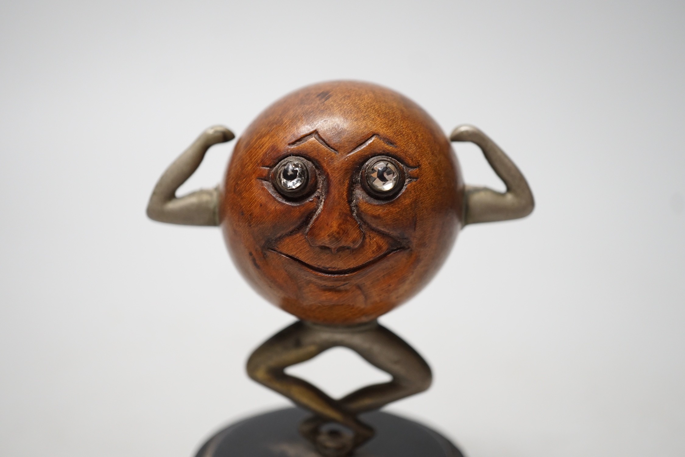 An early 20th century 'Touch Wud' figure, on an ebonised plinth 11cm tall